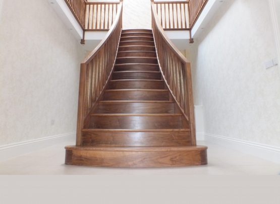 curved walnut staircase