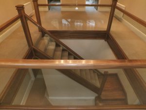 walnut staircase with glass and carpet