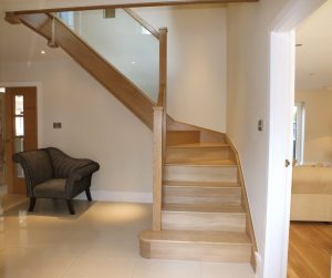 hardwood glass staircase with armchair