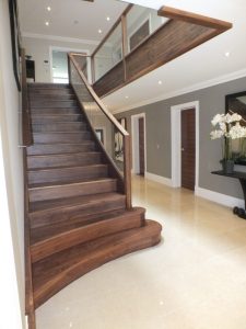 curved walnut staircase, interior design, glass balustrade