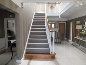 white curved staircase, oak handrail and step, grey carpet
