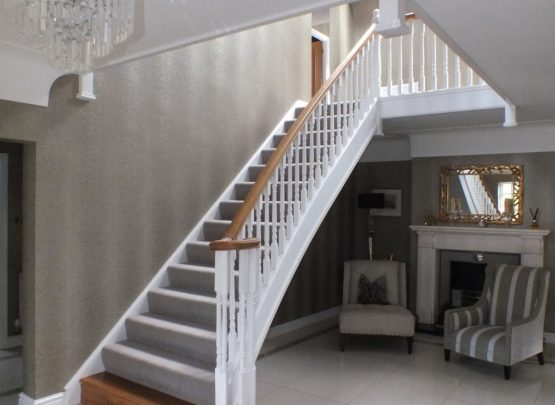 white staircase, oak handrail and bottom step