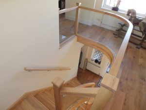 curved Ash staircase with glass