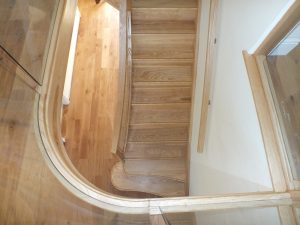 curved Ash staircase with glass