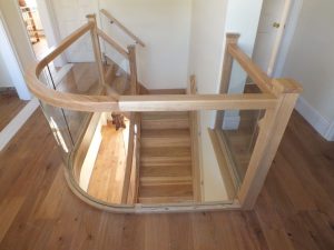 curved Ash staircase with glass