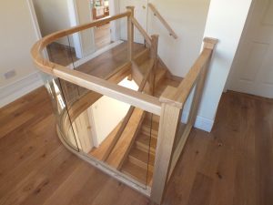 curved Ash staircase with glass