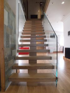 open plan, central spine staircase, free standing glass
