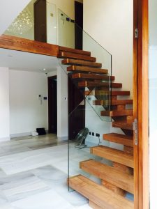 central spine staircase, free standing glass,