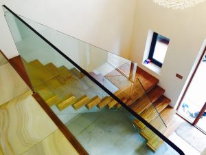 central spine staircase, free standing glass,