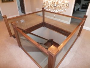 walnut staircase with glass and carpet