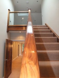 walnut staircase with glass and carpet