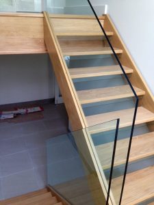 open plan staircase, free standing glass, cream tiles