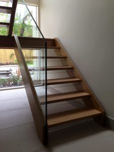 open plan staircase, free standing glass, cream tiles