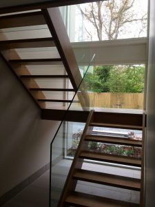 open plan staircase, free standing glass, cream tiles