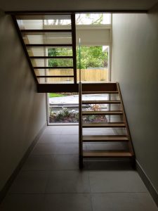 open plan staircase, free standing glass, cream tiles