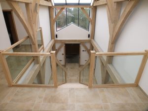 open plan glass staircase in barn conversion with large front window